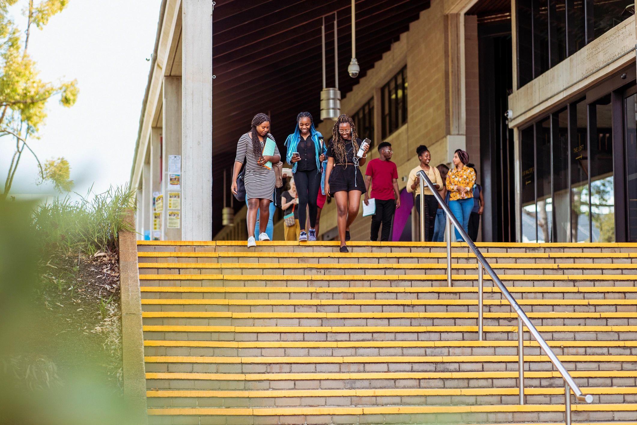 Group of students walking and talking on campus